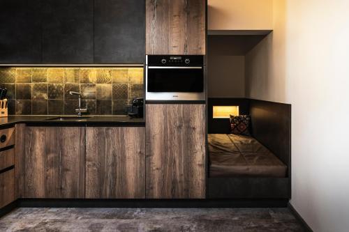 a kitchen with a sink and a microwave at PHILSON Apartments in Saalbach Hinterglemm