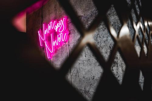 a window with a neon sign that says happy new year at PHILSON Apartments in Saalbach Hinterglemm