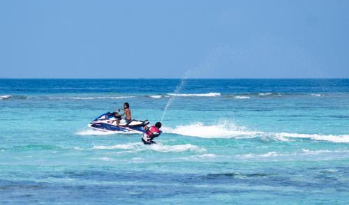 two people on a jet ski in the ocean at Manta Sea View Himandhoo in Himandhoo 