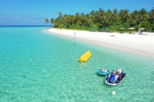 two boats in the water on a beach at Manta Sea View Himandhoo in Himandhoo 