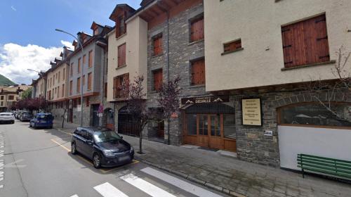a car parked on a city street next to buildings at Apartamento Temático "The Magic" in Biescas