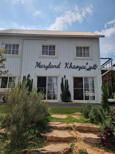 a white building with a sign on it at Maryland Khaoyai Annapolis Pool Villa in Ban Nong Song Hong