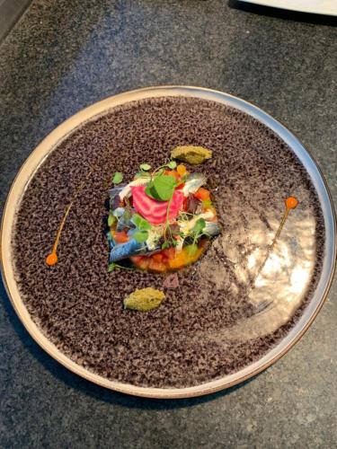 a plate with a piece of food on it at Logis Hotel Du Midi in La Roche-en-Ardenne