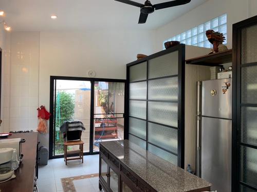 a kitchen with a refrigerator and a counter top at 155 SalaCoco in Ban Krut