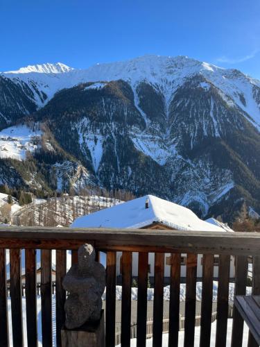 a view of a snow covered mountain from a deck at Chalet Wiesen in Davos