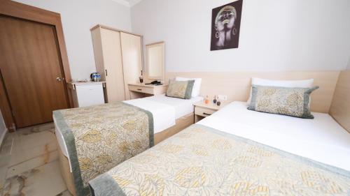 a hotel room with two beds at My Home Hotel Gulluk in Antalya