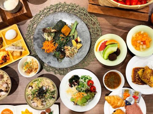 a table with many plates of food on it at Tabino Hotel Kurashiki Mizushima in Kurashiki
