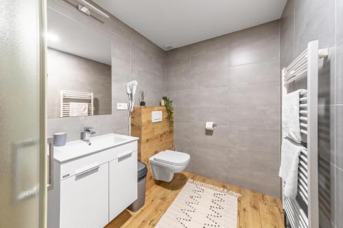a bathroom with a white sink and a toilet at Penzion Pepovka in Filipovice