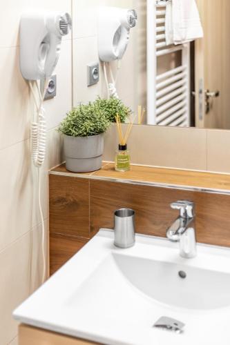 a bathroom with a sink and a mirror at Penzion Pepovka in Filipovice