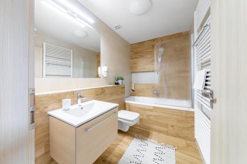 a bathroom with a white sink and a toilet at Penzion Pepovka in Filipovice