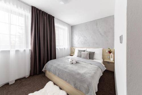 a bedroom with a bed with a teddy bear on it at Penzion Pepovka in Filipovice
