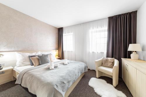 a hotel room with a bed and a chair at Penzion Pepovka in Filipovice