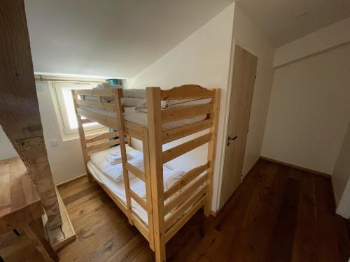 a bunk bed in a small room with a window at Domaine de Rozan - Col de Porte, Chartreuse - Grenoble in Sarcenas