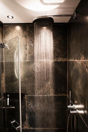 a bathroom with a shower with a shower curtain at PHILSON Apartments in Saalbach Hinterglemm