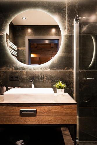 a bathroom with a sink and a mirror at PHILSON Apartments in Saalbach Hinterglemm