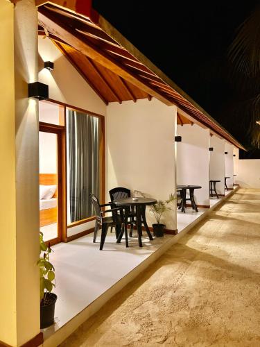 a row of tables on the outside of a building at Vilu Residence in Maamigili