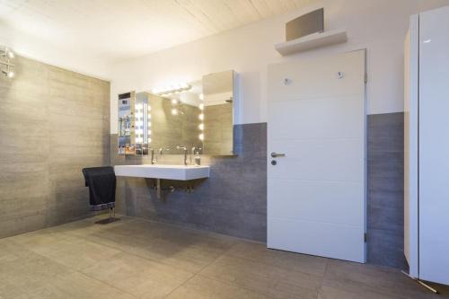 a bathroom with a sink and a mirror at City-Loft with rooftop terrace - 19 persons in Hannover