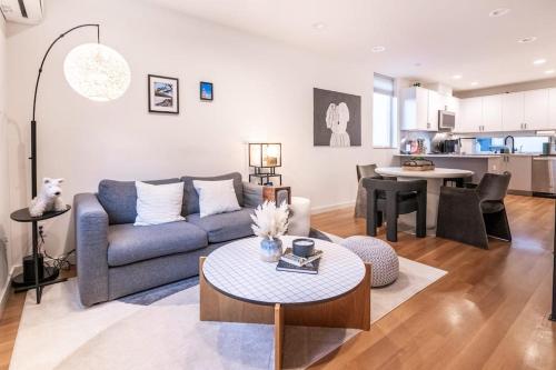 a living room with a couch and a table at Ballard's Pet-Friendly Mid Century Home + Rooftop Deck in Seattle
