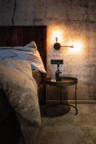a room with a bed and a table with a lamp at PHILSON Apartments in Saalbach Hinterglemm