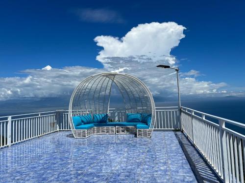a bird cage sitting on top of a balcony at OCEANO CON VISTA HIGHLAND in Tagbaobo
