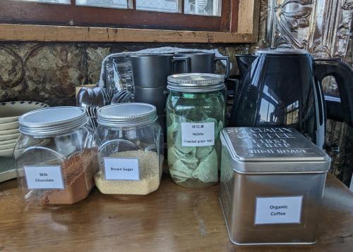 a group of jars of food sitting on a table at Guest House CARAPAN in Kagoshima