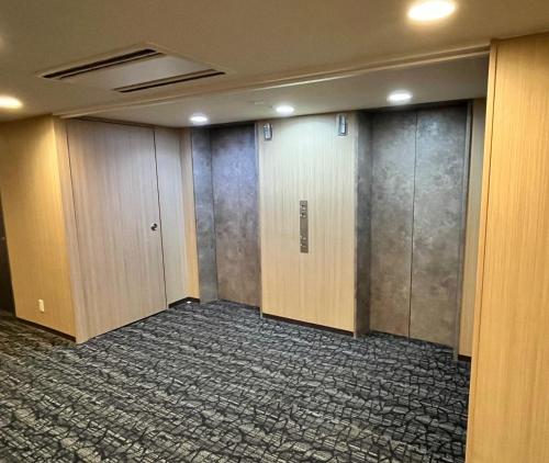 an empty room with doors and a hallway at Kumamoto Washington Hotel Plaza in Kumamoto