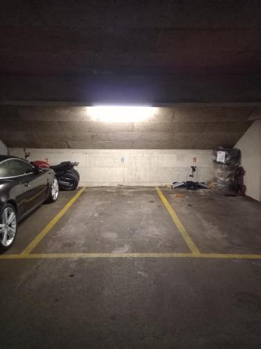 a parking garage with a car parked in it at Relax aux Paccots : été comme hiver in Les Paccots