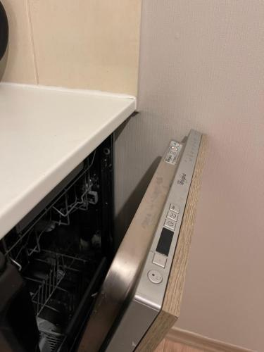 a kitchen with an oven with its door open at Cozy apartment close to Riga Airport in Rīga