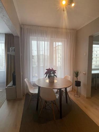 a dining room with a table and chairs and a window at Cozy apartment close to Riga Airport in Rīga