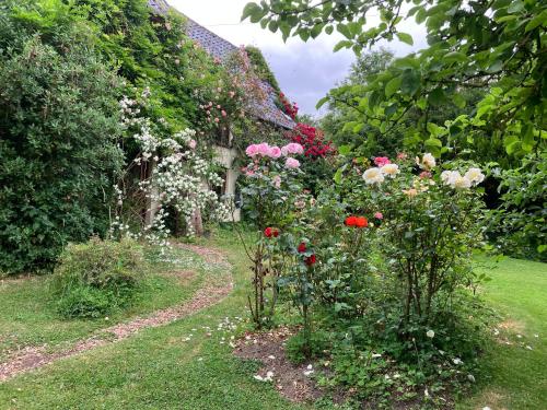 a garden with colorful flowers and a building at Valley Farmhouse, Westhall in Southwold