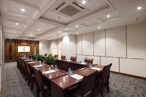 a large conference room with a long table and chairs at Daphovina Hotel in Nha Trang