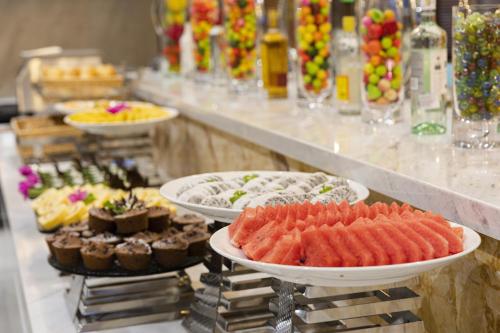 a buffet with many different types of food on plates at Daphovina Hotel in Nha Trang