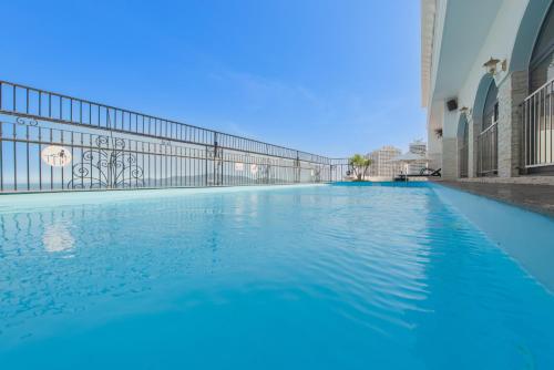 a swimming pool in a building with blue water at Daphovina Hotel in Nha Trang