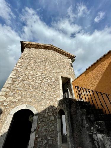a tall building with a fence next to it at Torretta Margiotta in Picinisco