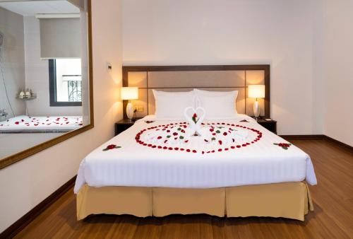 a bedroom with a bed with a heart made out of roses at Daphovina Hotel in Nha Trang