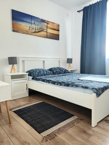 a bedroom with a bed and a desk at ADM Cozy Home - Entire private house&garden, close to Therme and Edenland in Tunari