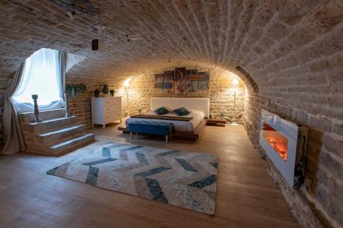 a bedroom with a bed and a brick wall at Loveappart21 l'expérience Bien Être in Dijon