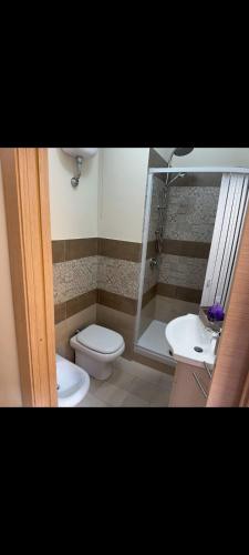 a bathroom with a toilet and a sink at KALGHEROS Luxury Rooms in Agrigento