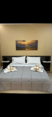 a bedroom with a bed with two towels on it at KALGHEROS Luxury Rooms in Agrigento