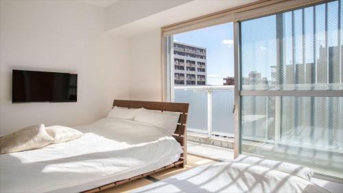 a bedroom with two beds and a large window at Kyoto - Hotel / Vacation STAY 73651 in Kyoto