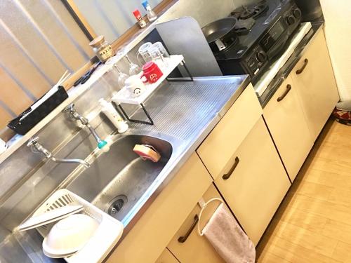 a kitchen with a sink and a stove at 10 minutes direct to Shibuya Crossing! Heart of Tokyo! Kamiuma in Tokyo