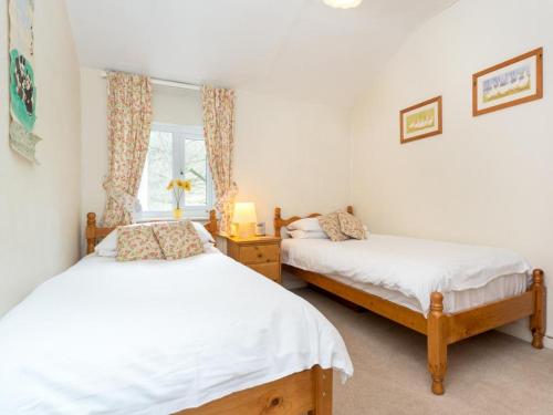 a bedroom with two beds and a window at 2 Bed in Borrowdale SZ068 in Rosthwaite