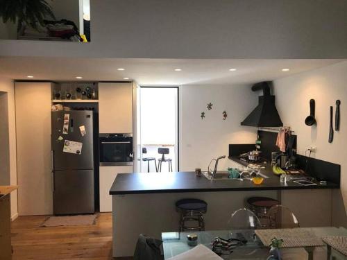 a kitchen with a black counter and a refrigerator at Casa Guido Eco Friendly in Lecce