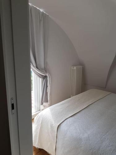 a bedroom with a white bed and a window at Casa Guido Eco Friendly in Lecce