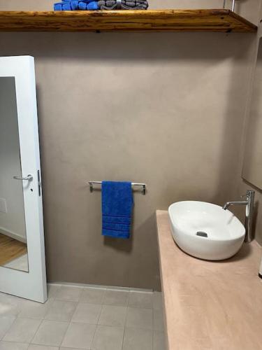 a bathroom with a toilet and a blue towel at Casa Guido Eco Friendly in Lecce