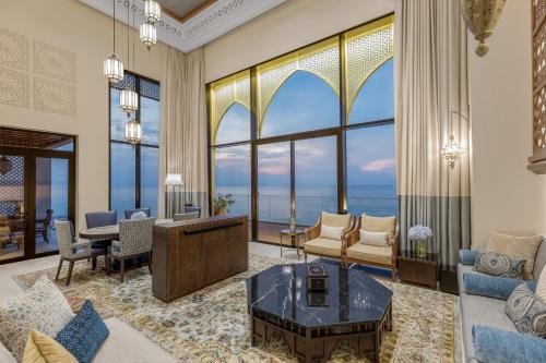 a living room with a view of the ocean at Sofitel Bahrain Zallaq Thalassa Sea & Spa in Manama