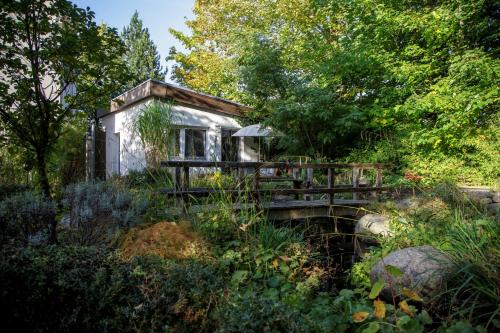 a small house in the middle of a garden at Hotel See-Villa in Malente