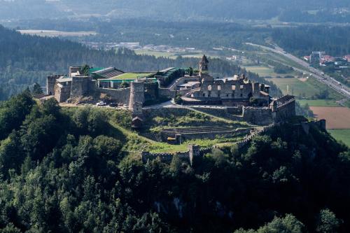 an old castle on top of a hill at Landhaus BERGSEE in Bodensdorf