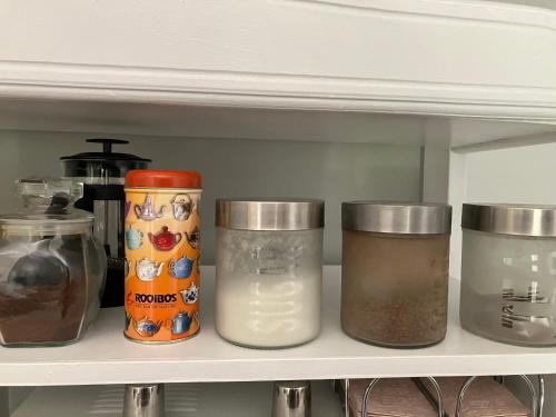 a shelf with jars of food on it in a refrigerator at Time & Again in Ceres