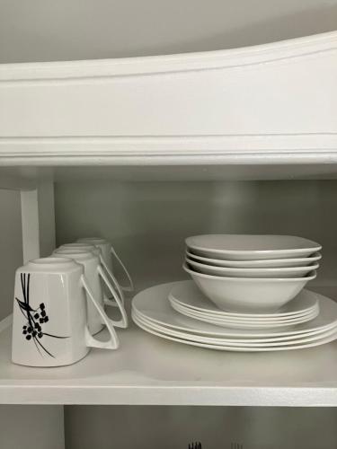 a shelf with plates and cups and dishes on it at Time & Again in Ceres